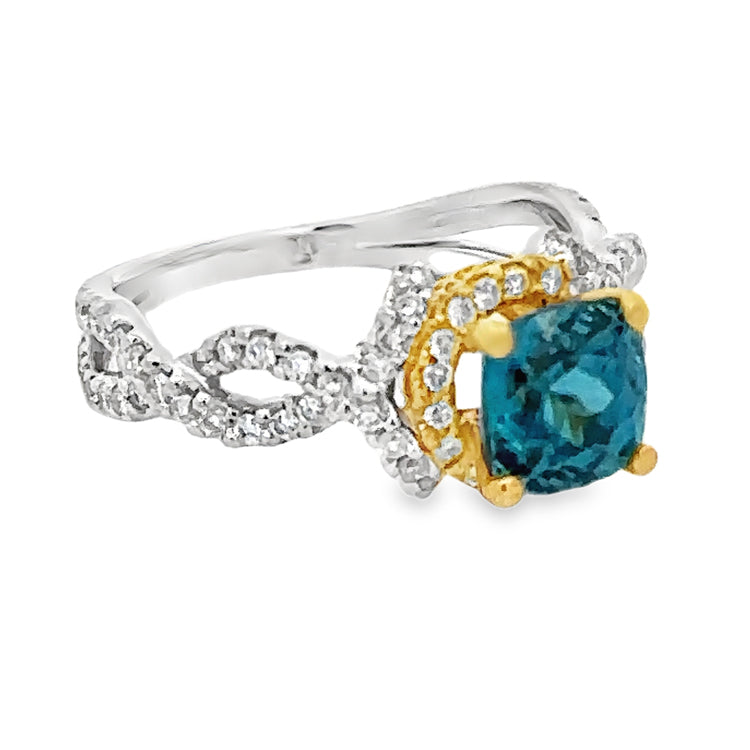 18Kt White and Yellow Gold Ring set with 2.13ct Round Blue Zircon and .54tw Diamonds, VS clarity and G-H color. Stock size 6 can be sized.  Dimensions; 8.4mm X 11mm top, 2.1mm shank