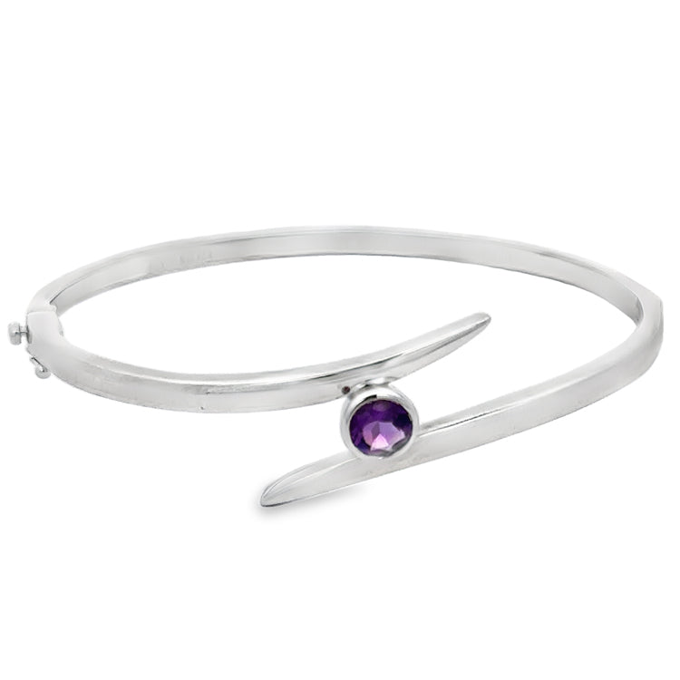 Sterling Silver Hinged Bangle Bracelet with bezel set genuine Amethyst in a bypass design. Fastens with a pressure clasp and supplemental safety-8.&amp;nbsp;