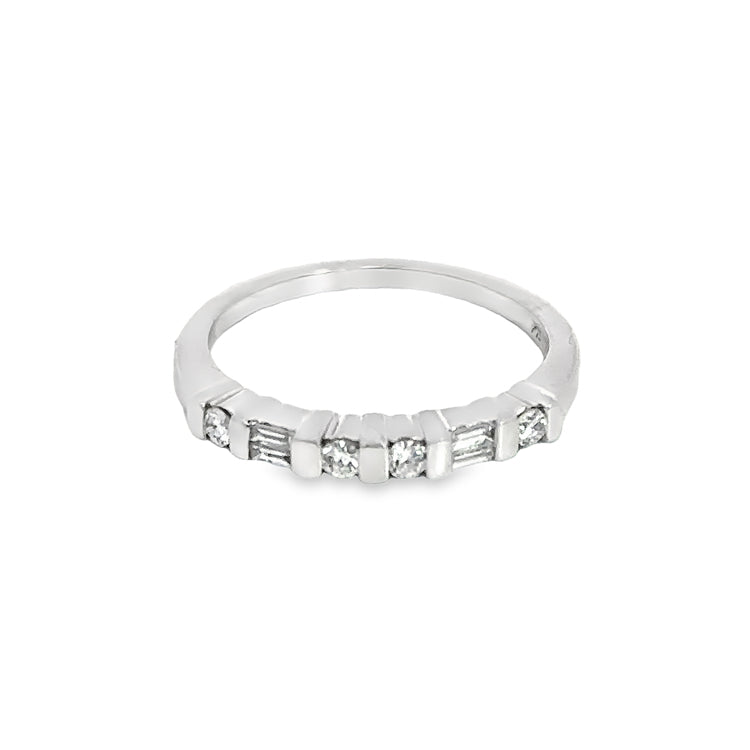 Estate Platinum band with approximately 0.25tw of channel set baguette (2) and round (4) diamonds across the top, SI1 clarity, G color. The top of the ring is 2.4mm wide and sits 3.6mm above the finger. This ring is size 6 and can be sized up or down at least 1 size.