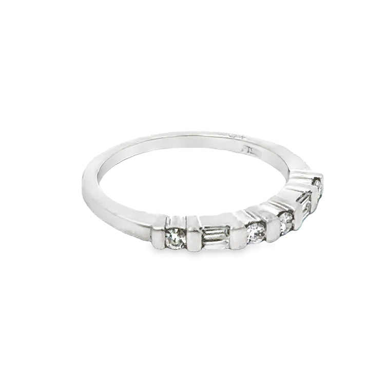 Estate Platinum band with approximately 0.25tw of channel set baguette (2) and round (4) diamonds across the top, SI1 clarity, G color. The top of the ring is 2.4mm wide and sits 3.6mm above the finger. This ring is size 6 and can be sized up or down at least 1 size.