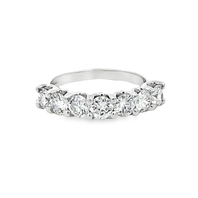 14Kt White Gold band with seven prong set round diamonds, totaling approximately 1.45tw, SI2 clarity, G color. Finger size 5.5 can be sized to order.  Dimensions; 4.1mm wide at top, 1.8mm wide at base of shank