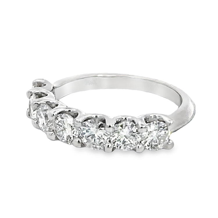 14Kt White Gold band with seven prong set round diamonds, totaling approximately 1.45tw, SI2 clarity, G color. Finger size 5.5 can be sized to order.  Dimensions; 4.1mm wide at top, 1.8mm wide at base of shank