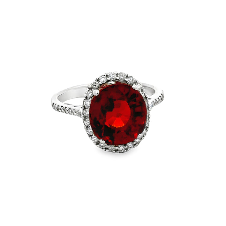 18Kt White Gold Ring with 5.68Ct Oval Rhodolite Garnet in a diamond halo on a diamod accented shank. Diamonds hava combined weight of .41TW  Dimensions: 13.77mm x 11.56mm center, 2mm shank width