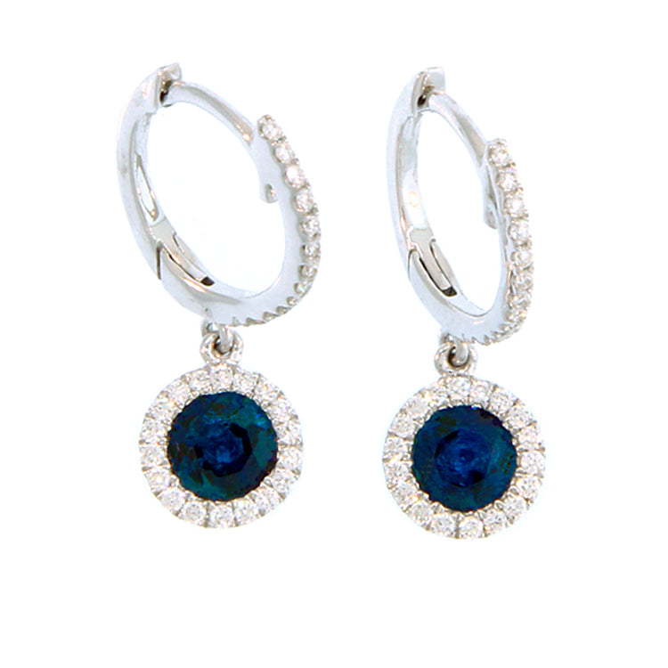 A pair of 14Kt white gold diamond huggies with diamond-framed sapphire dangles.