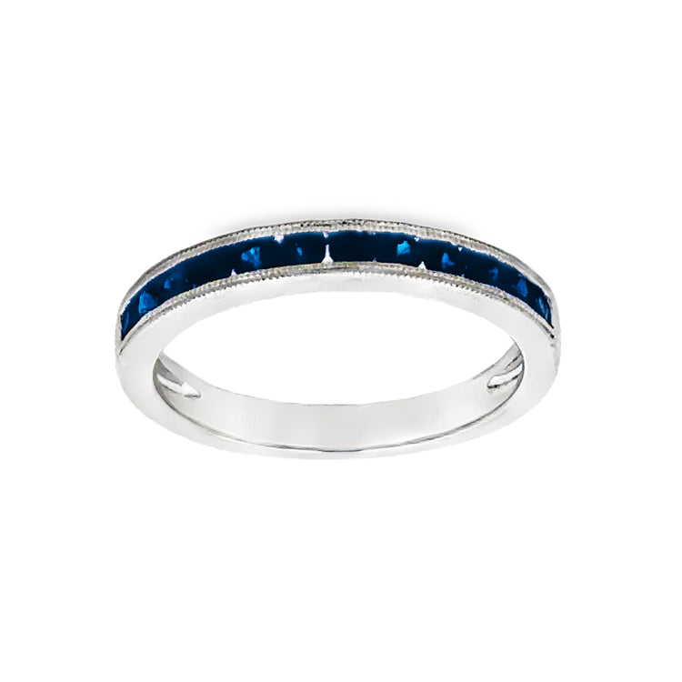 14Kt white gold, stackable band style ring with .55tw channel-set, round blue sapphires and accented with milgrain detail. Stock size 6.5 can be sized to order.  Dimensions; 2.8mm wide, 2.3mm high from top of finger.