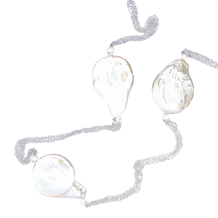 A 32-inch necklace featuring five strands of sterling silver with teardrop-shaped baroque freshwater pearls and semi-round freshwater pearls.