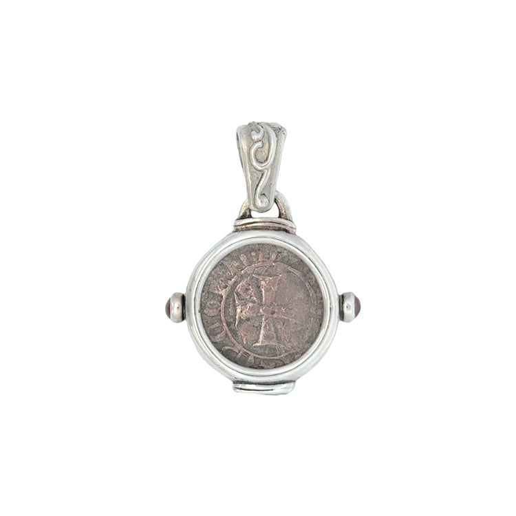 Venetian Tornesello coin, circa 1368-1423 CE, bezel set in a sterling Silver Pendant mounting with Garnet cabochon accents. The Obverse of the coin features the same cross design seen on the Frankish denier tournois within a lenged of the doge&#39;s name.