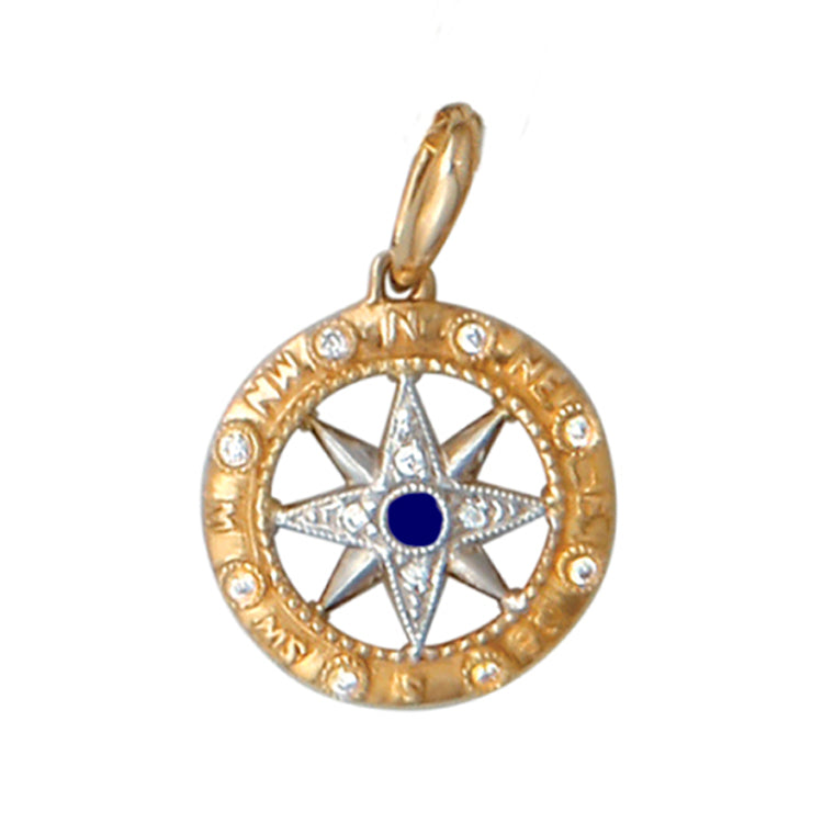 Two-tone Gold pendant with a compass rose design embellished with diamonds and a blue sapphire center.