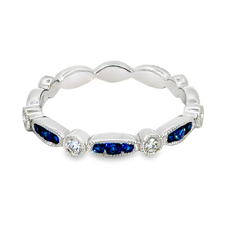 14Kt white gold, stackable band style ring with alternating navette and round sections that are accented with milgrain detail. The three ceter navette shapes are set with .17tw Round Blue Sapphires alternating with four round sections set with .17tw round diamonds. Stock size 6.25 can be sized to order.  Dimensions; 2.79mm wide top, 2.73mm shank, 2.4mm high from top of finger.