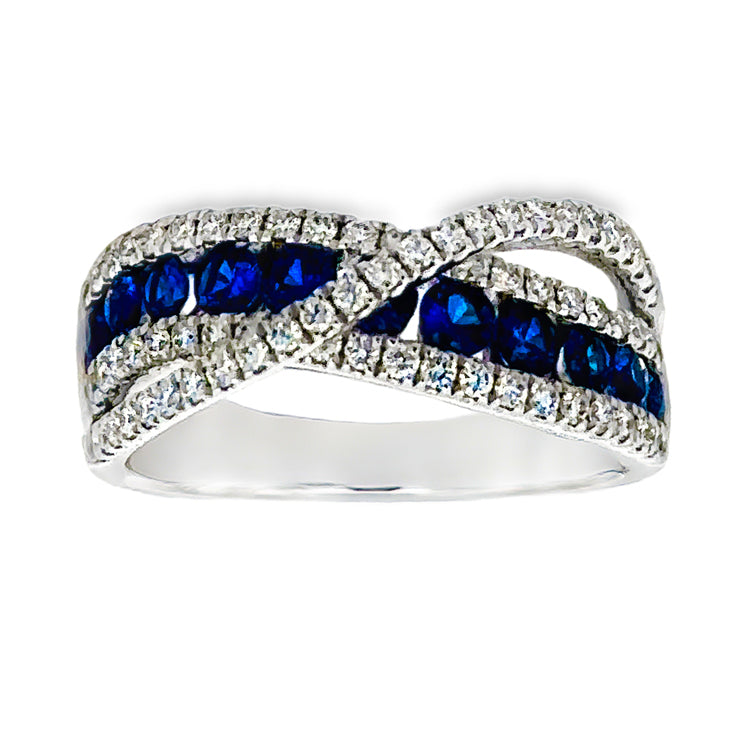 18Kt white gold curved band style ring with a row of .76tw round Blue Sapphires between two rows of Diamonds, with a raised crossover band of diamonds. Total diamond weight is .50tw. Stock size 6.5 can be sized to order.  Dimensions; 7.85mm wide at top, tapering to 3.24mm wide at base of shank. Top of ring is 4.42mm from top of finger.