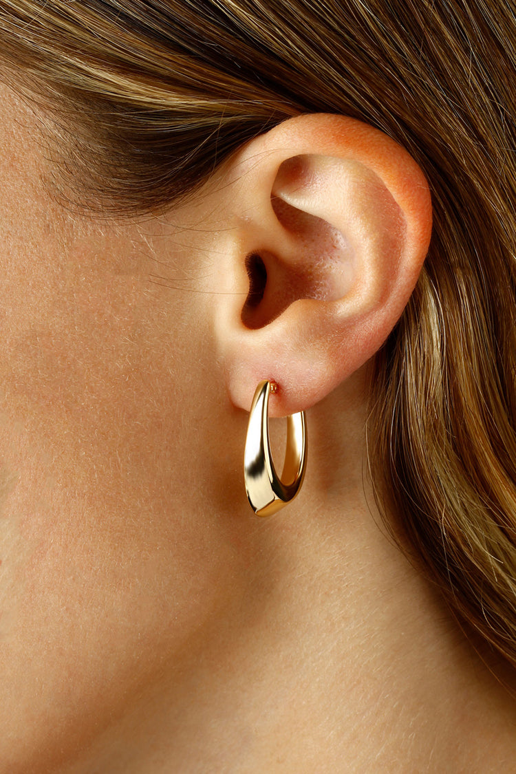 14kt Yellow Gold Tapered 1&quot; x 1/2&quot; Oval &quot;Visor&quot; Hoop Earrings with Snap Down Posts on Model&#39;s ear..