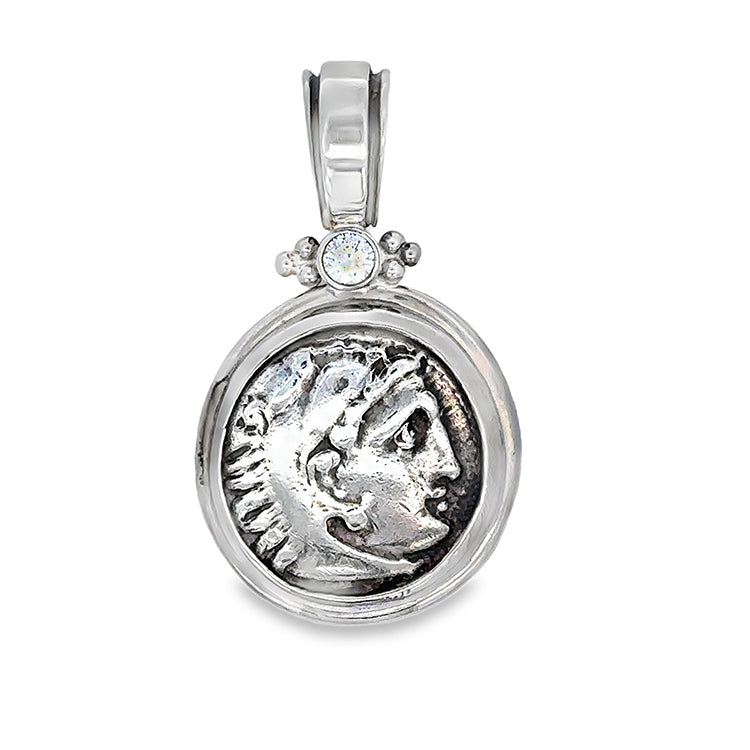 Ancient Greek Silver Drachm - Herakles/Zeus Coin Pendant Circa 336 - 323 B.C.&nbsp; Obverse: Head of Herakles right, wearing lion skin. Framed in 18Kt Palladium White Gold with .20CT Diamond.