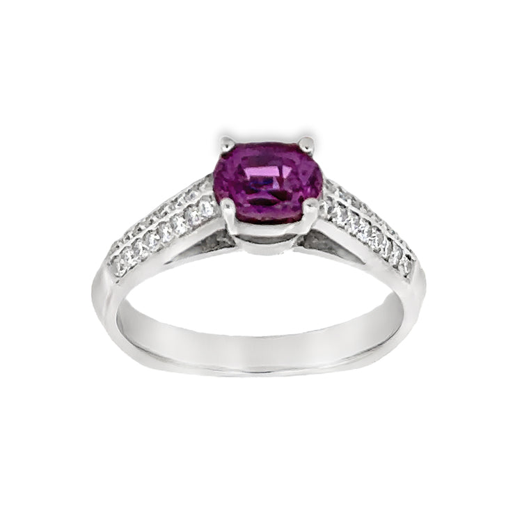 18Kt white gold ring featuring an East-West oriented, prong-set, 1.30ct Oval Fancy Plum Color Sapphire flanked by.26tw diamonds in the cathedral style shoulders. Stock size 7, can be sized to order.  Dimensions; Top of ring is 5mm wide and tapers to 2.7mm at the base of the squared Euro-Style shank.