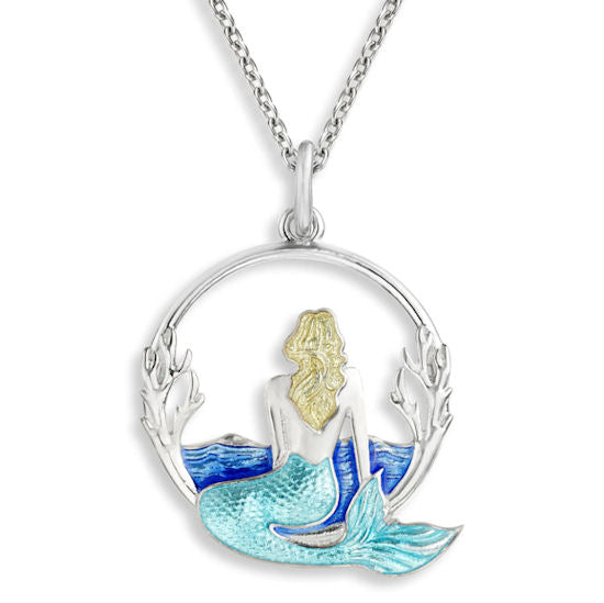 Silver pendant on a chain featuring a blonde mermaid with a turquoise tail looking at the blue water as she sits on the rim of a silver circle.